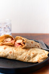 Fresh chicken roll with fresh tomatos, salad, wrap