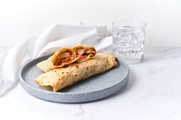 Two fresh chicken and salad tortilla wraps