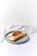 Fresh chicken roll with fresh tomatos, salad, wrap