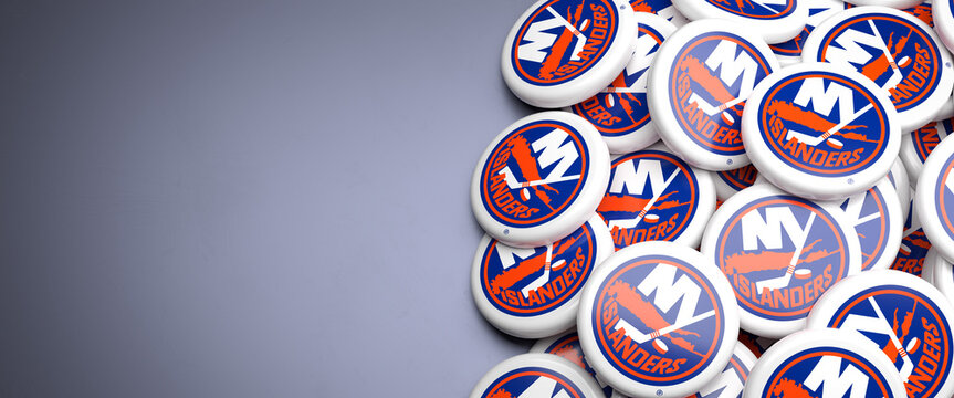 Logos of the American National Hockey League NHL Team New York Islanders on a heap on a table.