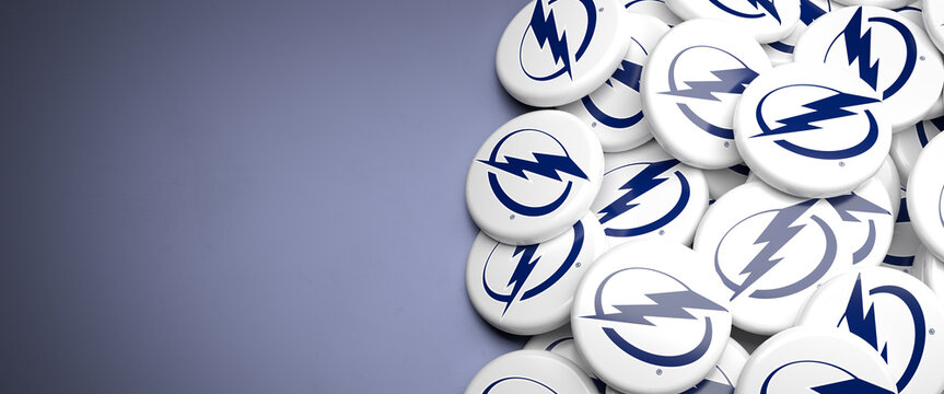 Logos of the American National Hockey League NHL Team Tampa Bay Lightning on a heap on a table.
