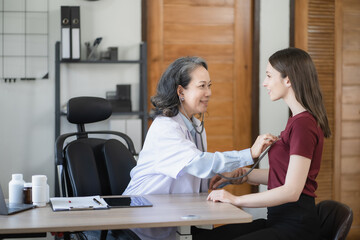 Doctor with stethoscope examining patient with examination, presenting symptoms and recommending treatment, healthcare and medical concept.