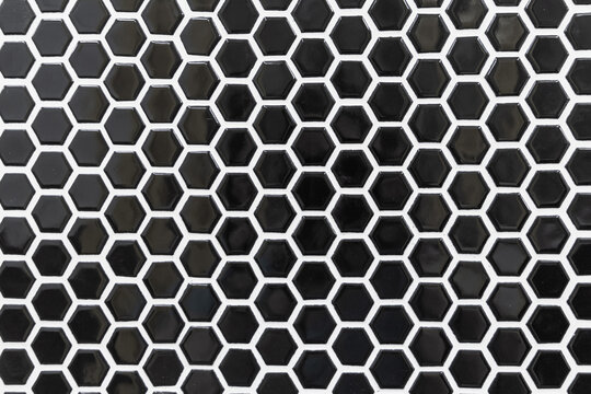 Black octagon tile with white grout in a backsplash, shower, bathroom wall area