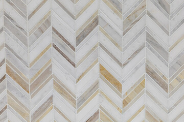 White, gray and brown marble herrinbone tile on a bathroom wall or kitchen backsplash