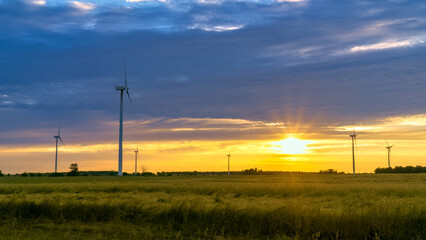 Obraz premium Sunrise and wind turbines over the farmlands of the Garden Peninsula, Michigan