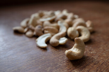 Fototapeta premium Tasty cashew nuts as background, top view