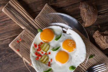 Fried eggs from two eggs on a plate, top view, healthy breakfast concept