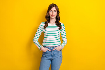 Obraz na płótnie Canvas Portrait photo of confident student young gorgeous adorable woman wear denim jeans hands pockets stylish outfit isolated on yellow color background