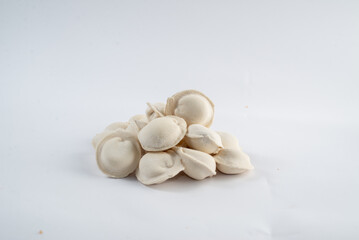 Frozen semi-finished dumplings on a white background