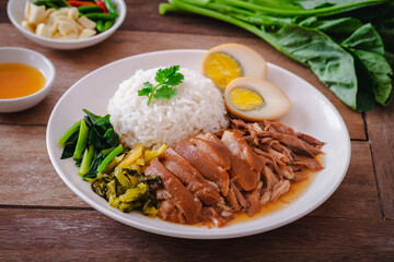 Stewed pork leg with boiled egg and rice on plate