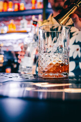 man hand bartender making cocktail in glass on the bar counter