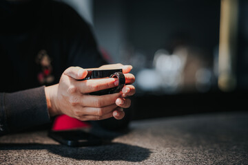 Male hand holding a large cup of black latte coffee man wearing warm black knit sweater.