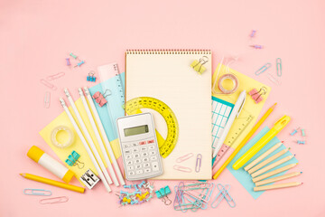 stationery items for girls or women on light pink background. Back to school. Female Student's, pupil's or engineer's supplies. Office objects on pastel pink background. Calculator, keyboard - 574676976