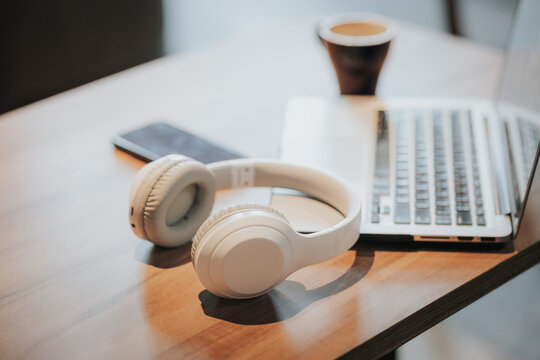 Modern wireless headphones and laptop computer while resting. organizing a workspace or home office work from home with copy space for.