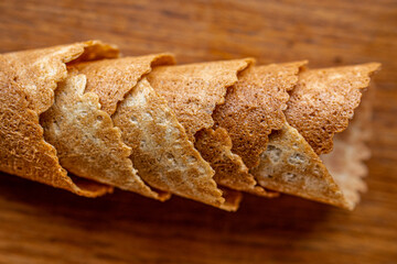 horizontal photo of five ice cream cones on a wooden background