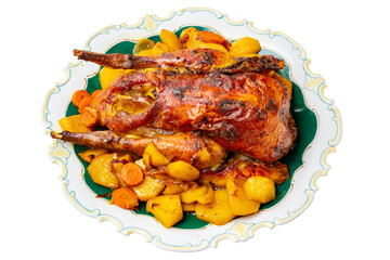 Grilled whole guinea fowl or baked pearl chicken on roasted potatoes and vegetables and port wine sauce is served on a beautiful plate. Clipping path. Isolated on white.
