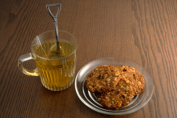Hot tea and cookies on wooden table