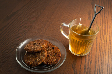 Hot tea and cookies on wooden table