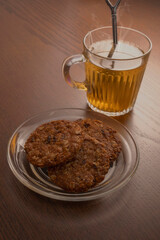 Hot tea and cookies on wooden table