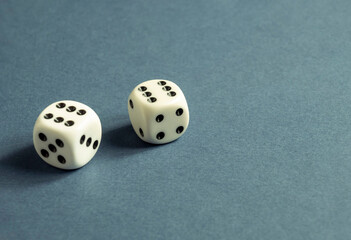Random number generator. Two white dice with numerical values lie in a chaotic order.