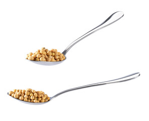 metal spoon with soybeans isolated on white background.