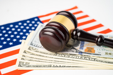 Gavel for judge lawyer and US dollar banknotes on USA America flag, finance concept.