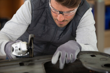 mechanic worker repairman sanding polishing car