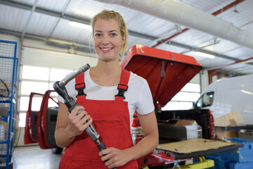 portrait of female mechanic with air socket