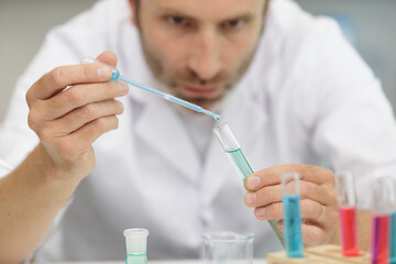 scientist using test tubes in laboratory