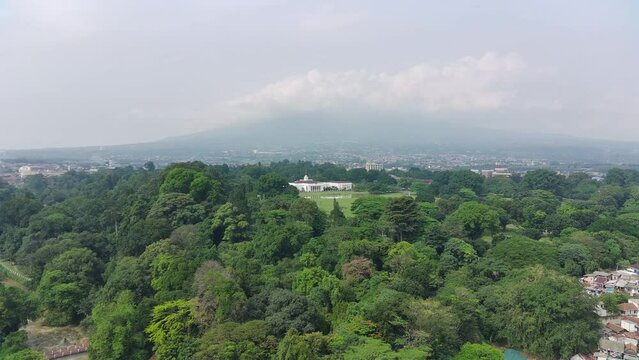 4K footage aerial view of the presidential palace building in the middle of a botanical garden.