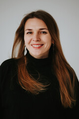 beautiful middle aged real woman portrait on white background, emotions of joy and smile, professional and selfmade businesswoman