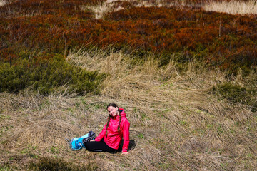Naklejka na ściany i meble Backpacker girl enjoys a hike during spring in the Bieszczady Mountains, Poland, Europe