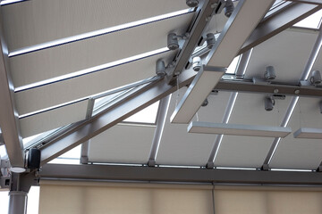 Motorized pleated blinds on the roof windows. Cellular blinds for skylights, beige color. Honeycomb...