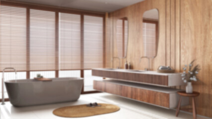 Blurred background, minimalist wooden bathroom. Freestanding bathtub and washbasin with mirror. Marble tiles floor. Japandi interior design