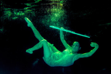 Fototapeta na wymiar Model underwater with flute floating