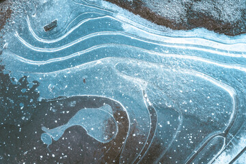 Blue ice formation with white curvy snow stripes and bulb-shaped ice formation that resembles...