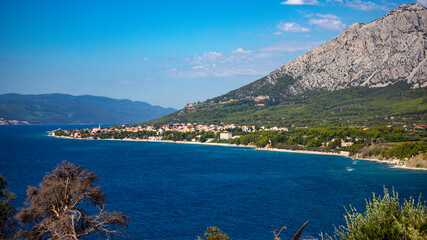 Naklejka premium panorama of the peljesac peninsula coastline in croatia; an amazing Mediterranean coastline with rocks and green hills over turquoise water