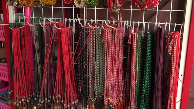 Keychains, necklaces, bracelets, and other monk accessories hang in the shop