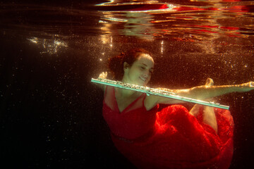 Model underwater in pool with flute © dfriend150