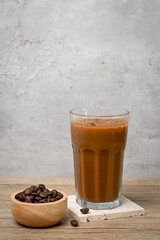 Iced coffee in a glass placed on a wooden table. Coffee Espresso made from fine coffee beans gives a pleasant aroma.