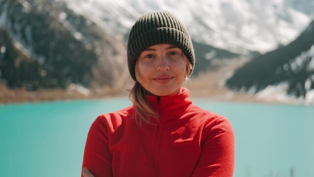 Portrait of young girl traveler hiker looking at the camera. Enjoy nature and life. Traveling in the mountains, adventure in trip. Lifestyle concept. Freedom, Happiness. High quality 4k footage