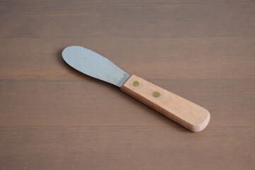 A silver knife on wooden table