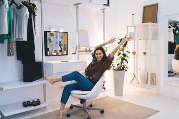 Joyful woman stretching body on chair
