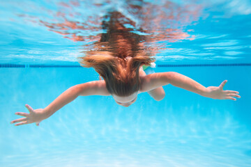 Child boy swim under water in sea. Kid swimming in pool underwater. Happy boy swims in sea underwater, active kid swimming, playing and diving, children water sport.