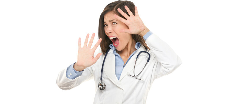 Screaming scared doctor woman afraid and frightened covering her face with hands showing funny expression shocked and surprised. Female medical health care professional isolated on white.
