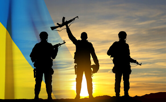 Silhouettes of soldiers with Ukraine flag against the sunset. Armed forces of Ukraine concept. EPS10 vector
