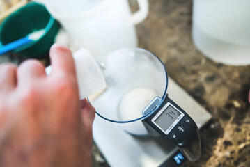Mixing ice cream ingredients and measuring them with a kitchen scale. High quality photo