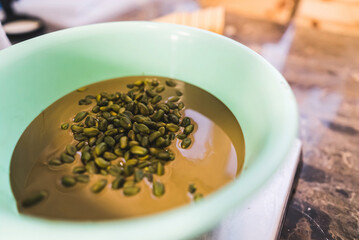 Chocolate ice cream mixture with whole pistachios in a bowl. High quality photo