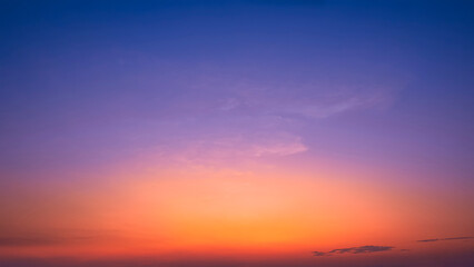 Colorful Dusk Sky background in the Evening with beautiful orange sunlight and cloud on dark blue Twilight after sundown