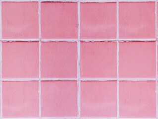 Pink brick wall background with white joints, close-up view